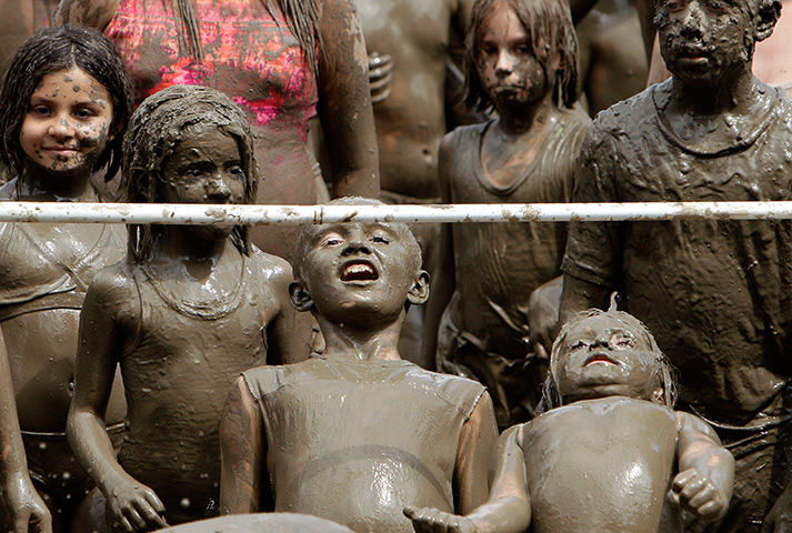 Mud day: Children do the limbo 