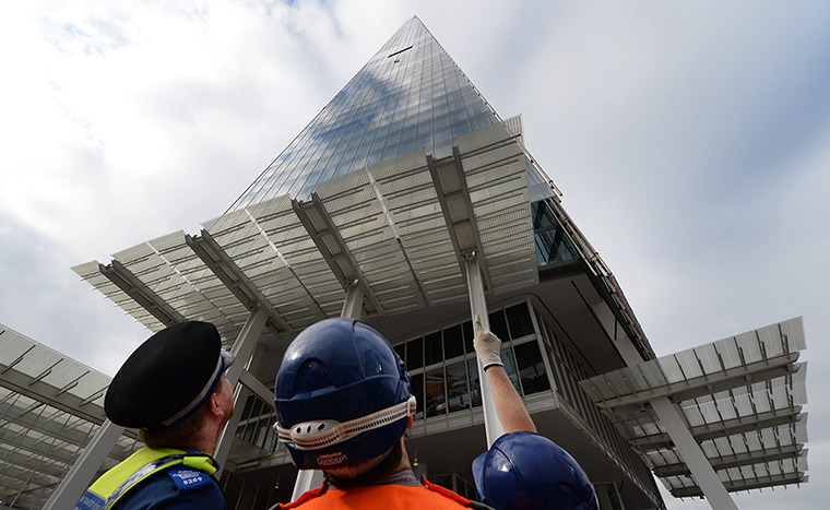 Greenpeace Shard: A policeman and emergency services personnel watch 