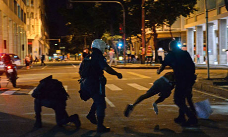 Riot police tackle a protester during clashes in Rio that marred a plan peaceful day of action
