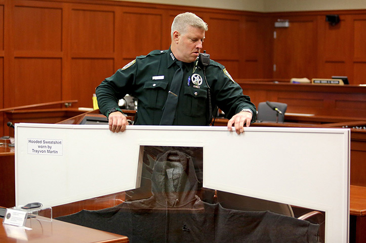 Zimmerman not guilty: A Sheriff's deputy carries Trayvon Martin's hooded sweatshirt