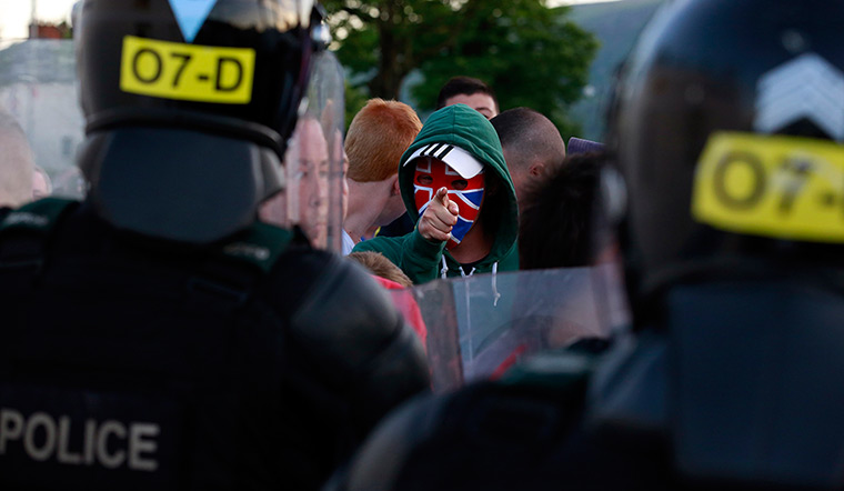 Belfast unrest: A Loyalist protester gestures to the police 