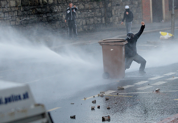 Belfast unrest: Police deploy a water cannon after being attacked by youths throwing bricks