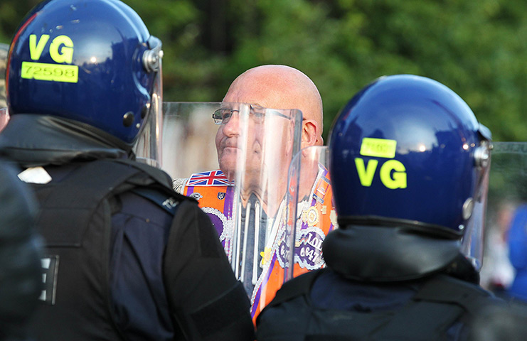 Belfast unrest: An Orangeman confronts riot police as a small protest is stopped along Shan