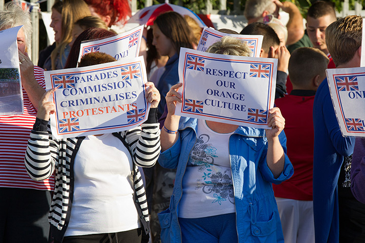 Belfast unrest: Protesters hold up placards in respect to the recent Parades commission rul