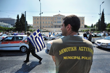 Municipal police officers protest in front of the Parliament in Athens, Greece, 15 July 2013.