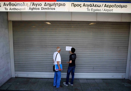 Commuters read a notice at the closed entrance of central Syntagma square station during a general strike in Athens July 16, 2013.