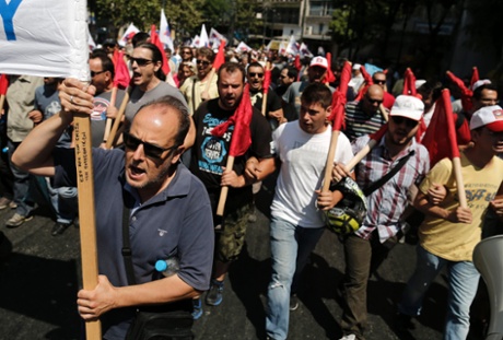 Supporters of the Communist-affiliated trade union PAME take part in an anti-austerity rally in Athens, July, 16, 2013, during a 24-hour general strike.