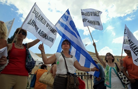 Protesters hold flags in front of the Greek Parliament during a demonstration in central Athens, Greece, 16 July 2013.