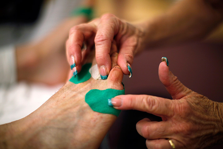 FTA Lucy Nicholson: A competitor has his feet examined by a medical person