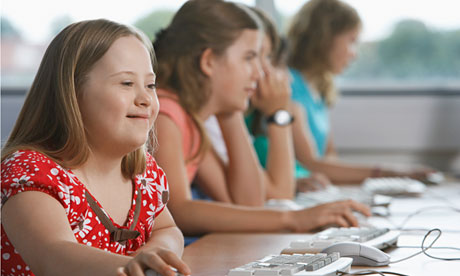 A girl with Down's syndrome using a computer