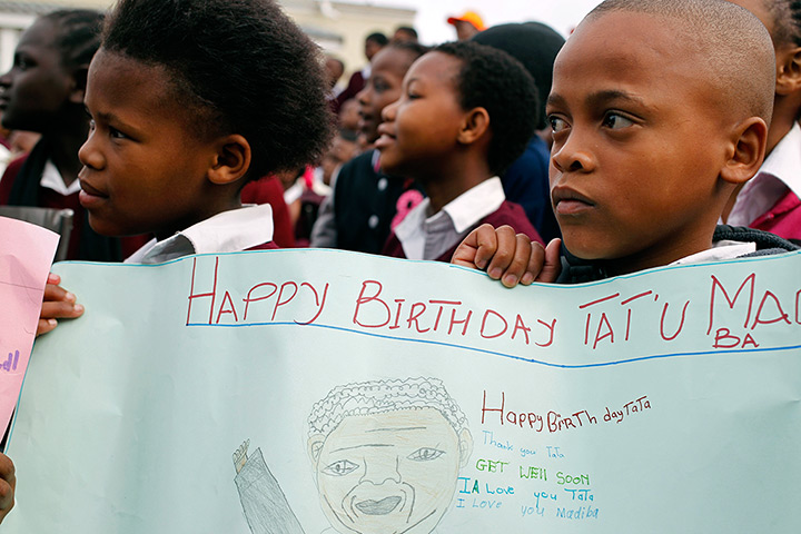 Mandela's birthday: Children hold up a poster at a school in Cape Town