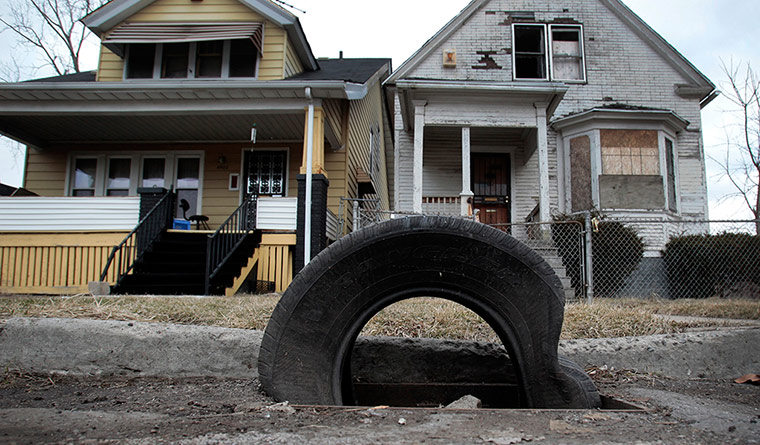 motor city blues: A tire sits on a storm drain as a replacement for a cast iron grate