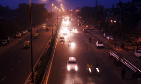 Traffic on the road at night in Delhi.
