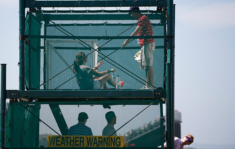 Open Golf : Scoreboard staff work inside a scoreboard during the second round