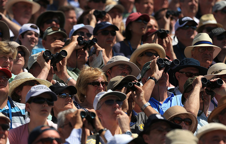Open Golf : Spectators watch from the stands through binoculars during day two
