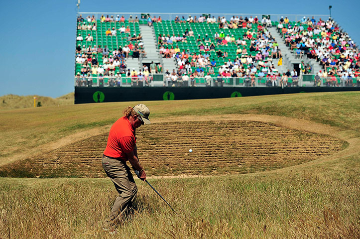 Open Golf : Spain's  Miguel Angel Jimenez chips onto the fourth green 