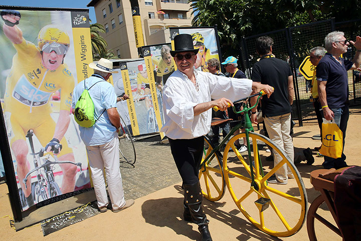 Tour de France stage 3: A disguised man holds a bike in Ajaccio