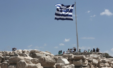 A Greek flug flutters at the top of the Acroplis hill in Athens July 2, 2013.
