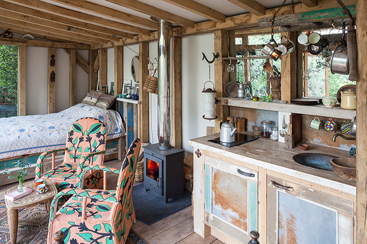 Homes - Bristol House - The bed, kitchen and logon stove in the cabin