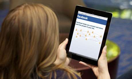 woman using facebook on ipad