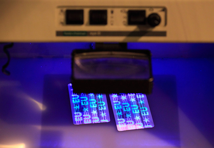 Croatia border patrols: Documents under ultra violet light at the border crossing in Bajakovo