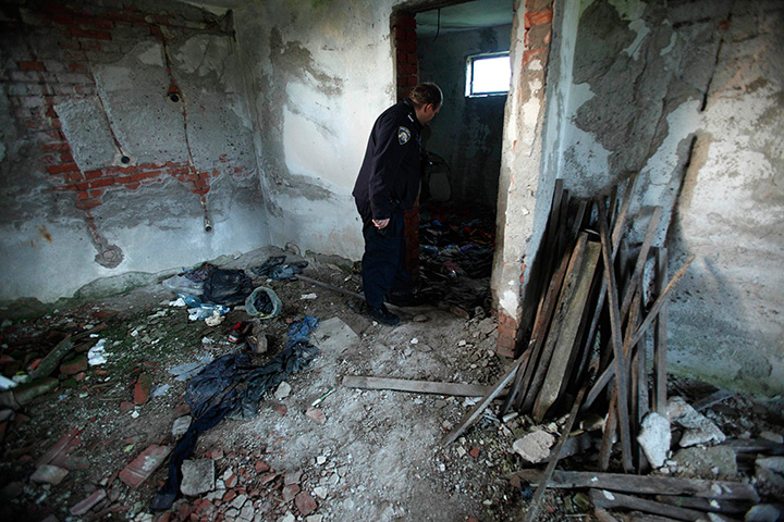 Croatia border patrols: A border police officer inspects an old house near the Croatia-Serbia borde