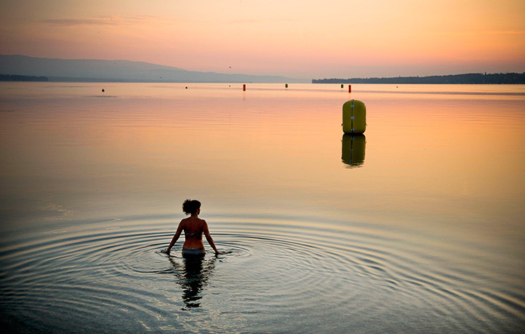 Weekend in pictures: Geneva, Switzerland: A woman swims at sunrise at Lake Geneva