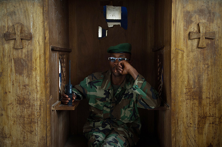 Weekend in pictures: Rumangabo, Democratic Republic of the Congo: An M23 soldier sits in a confe