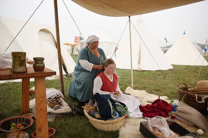 History Live! event: A 'War of the Roses' re-enactor plaits a child's hair 