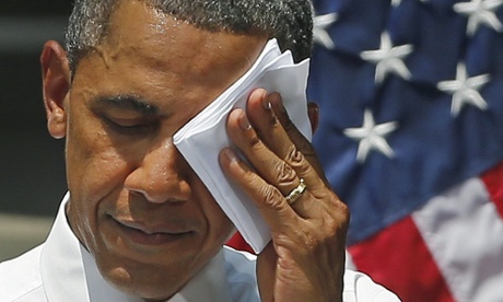 President Barack Obama wipes perspiration from his brow during an ambitious speech about climate change under a steaming hot sun at Georgetown University in Washington.