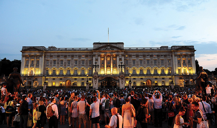 Royal blue: Members of the public gather outside Buckingham Palace after an easel was p