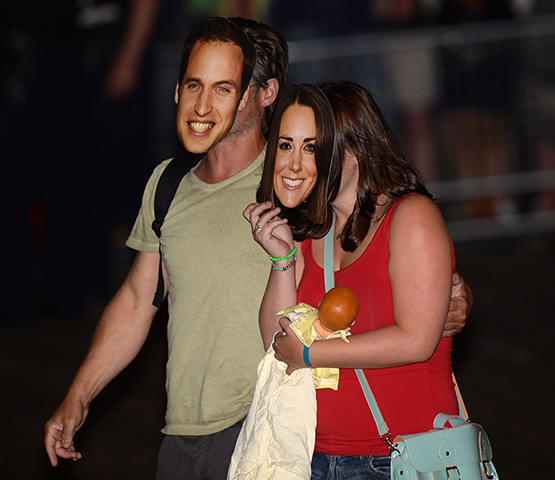 Royal blue: Members of the public wear masks as they celebrate the announcement of the 