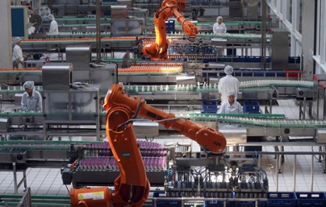 Employees work inside a milk factory in Beijing, July 5, 2013.