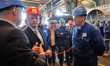 French President Francois Hollande (2ndL), wearing a helmet, speaks with employees of the CMP boiler factory in Dunkirk, northern France, July 23, 2013 as part of a visit focused on employment, professional training and social dialogue.
