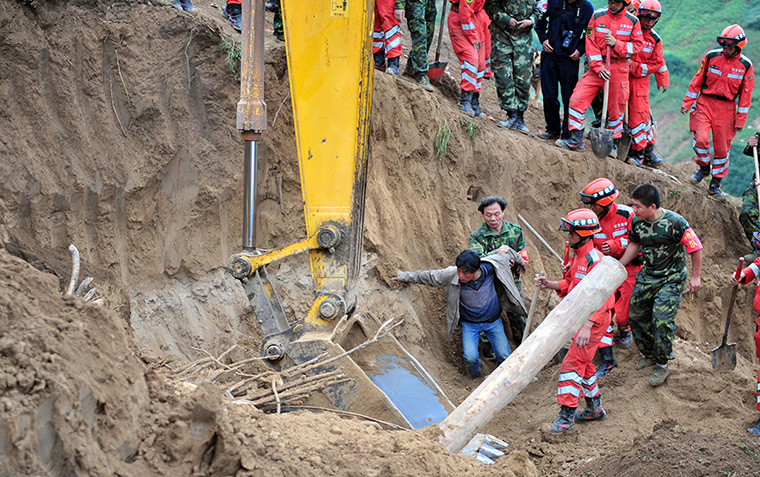 China earthquake: A man jumping into the ruins upon seeing his wife's shoes as rescuers searc