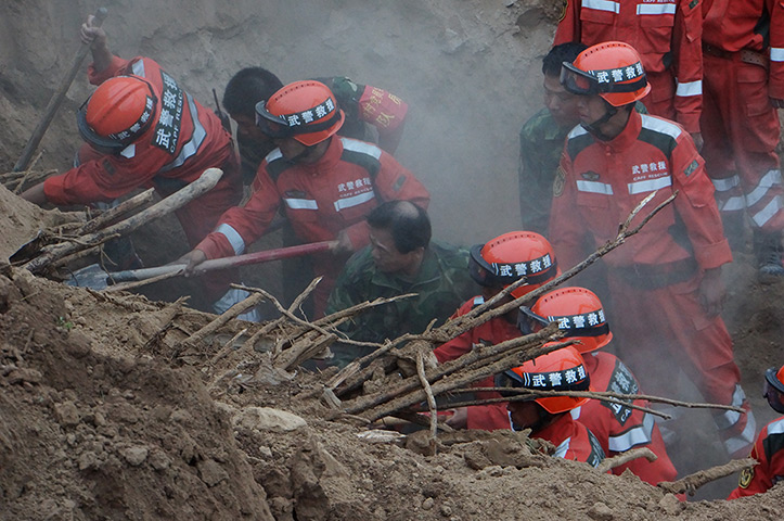 China earthquake: Rescuers search for buried people at the site of a mudslide at Yongguang vi