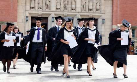 Graduates leave the Great Hall after a degree ceremony at Birmingham University UK