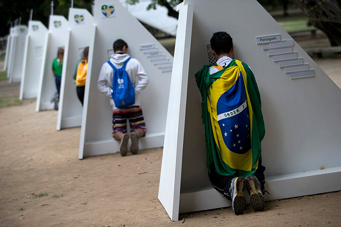 Pope in Brazil: Catholics kneel at portable confessionals set up in Quinta da Boa Vista par