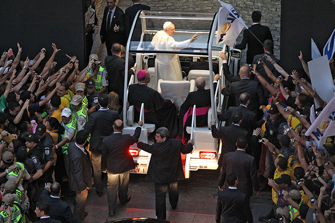 Pope in Brazil: Pope Francis waves from the popemobile on his way to the Guanabara Palace a