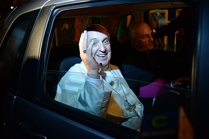 Pope in Brazil: Pope Francis waves for the car as he leaves the Guanabara Palace in Rio de 
