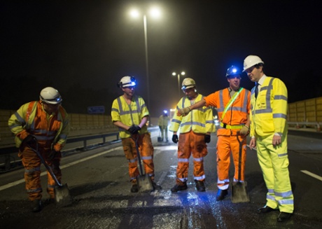 Chancellor of the Exchequer George Osborne meets workers on a section of the M6 motorway near Birmingham where he saw a road management scheme being constructed whilst the road was closed