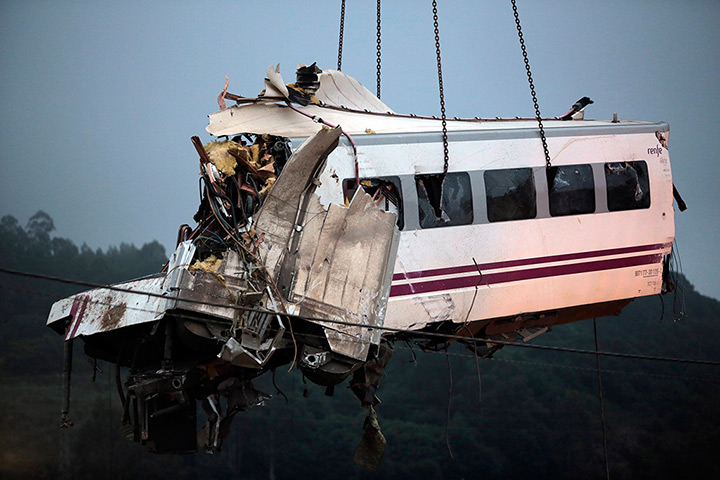 Spanish train crash: A crane removes a carriage from the tracks at the site of a train crash