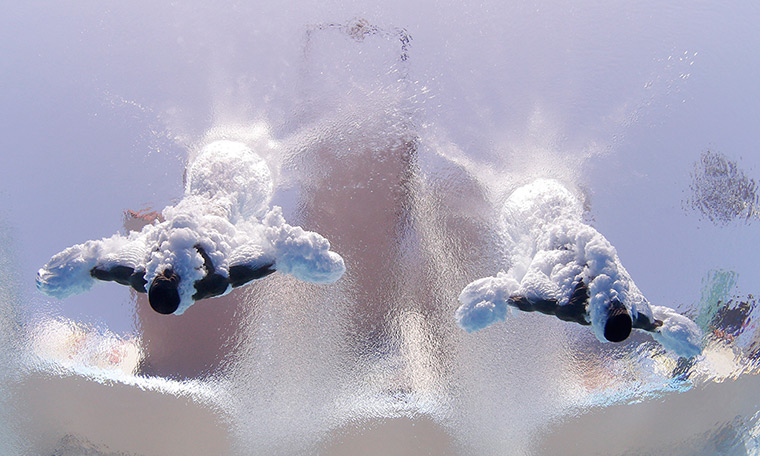 Divers underwater: Jeinkler Aguirre and Jose Guerra of Cuba  compete in the men's 10-metre syn