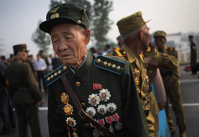 North Korea 60th: Veteran North Korean soldiers arrive in full military dress to pay their re
