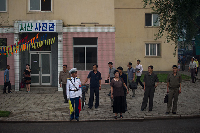 North Korea 60th: Commuters wait at a bus stop in Pyongyang