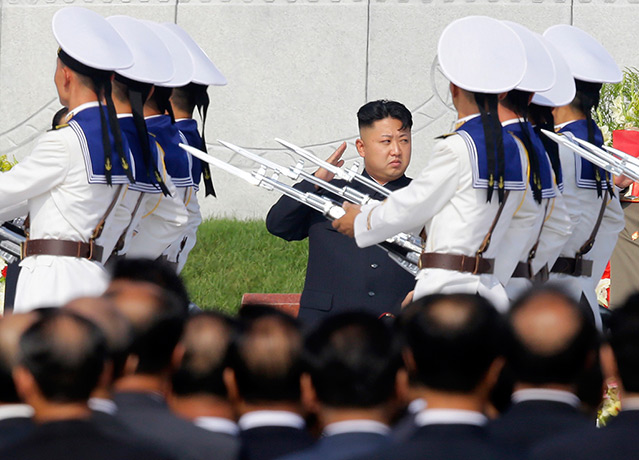 North Korea 60th: North Korean leader Kim Jong-un salutes as honour guards march past as he a