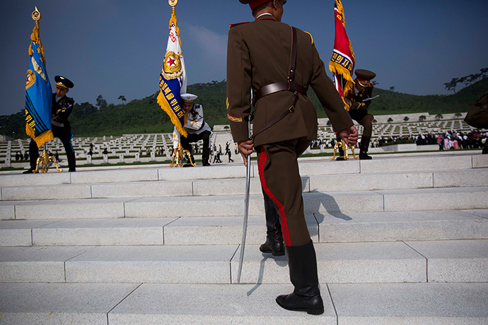 North Korea 60th: North Korean honoru guard soldiers lift their flags at an opening ceremony 