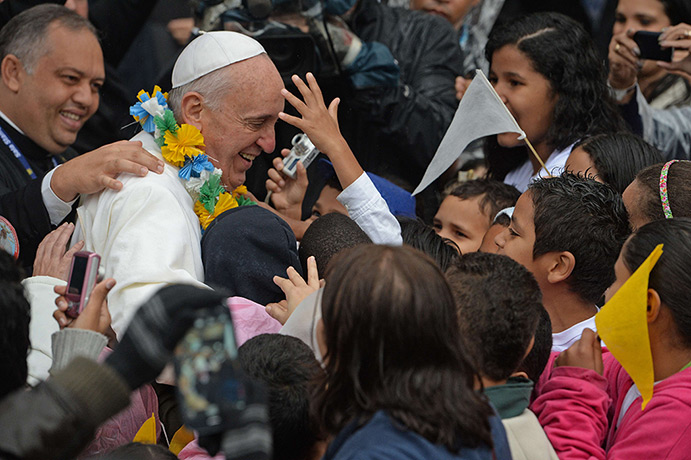 Pope in Brazil: Pope Francis is surrounded by children during his visit to the Varginha fav
