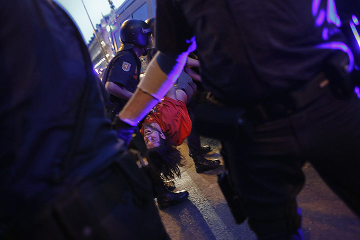 20 Photos: Police officers detain a demonstrator during a protest in Madrid