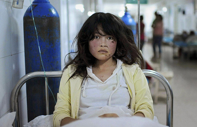 20 Photos: An injured woman at a hospital after a 6.6 magnitude earthquake hit Dingxi